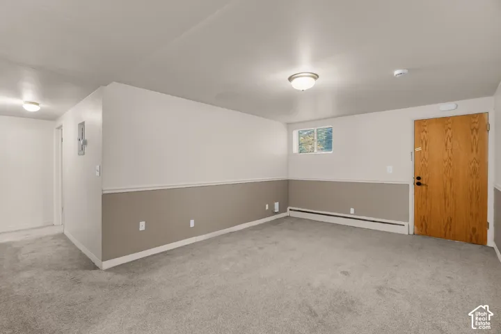 Carpeted flooring, two-tone wall paint, recessed window, and flush-mount ceiling lighting