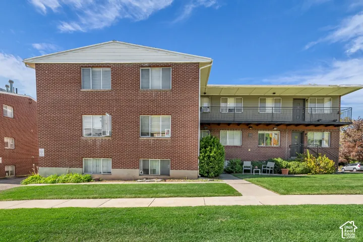 Brick exterior construction featuring multiple windows and a flat roofline