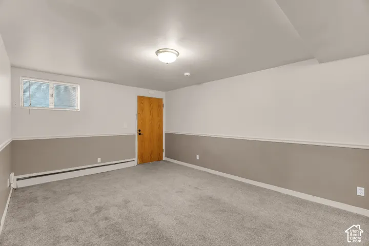 Wall-to-wall carpeting, two-tone painted walls, and a flush mount ceiling light fixture