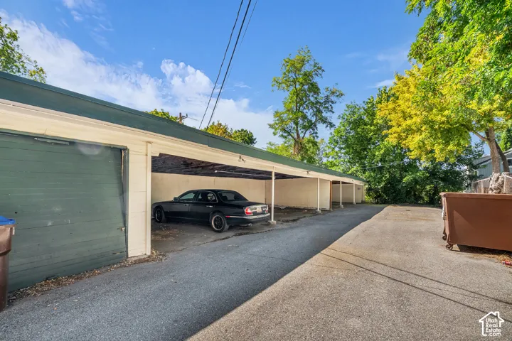 Covered parking structure with multiple open bays and a closed garage