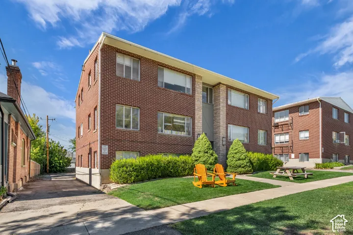 Brick exterior facade with stone-clad accents and multiple windows