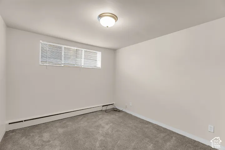 Neutral-toned walls complement the gray carpeting