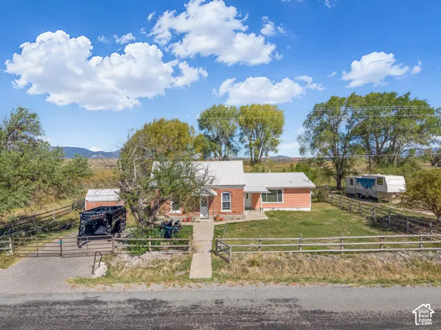 Single-story residence featuring a metal roof and a fenced yard