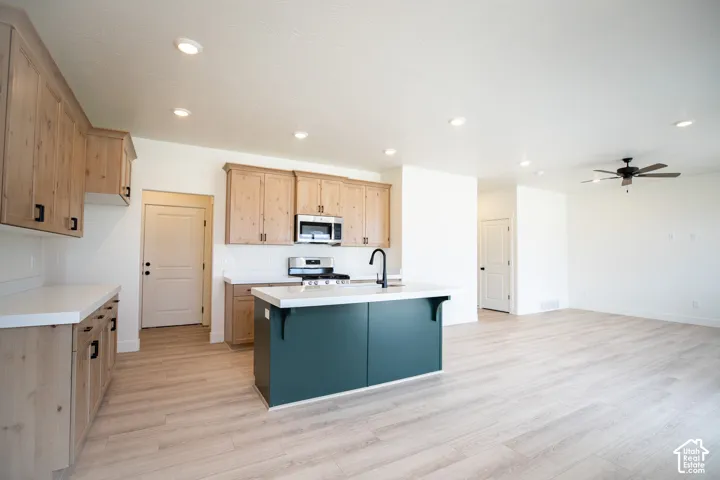 Terrific kitchen with 42" uppers, stained wood cabinets, painted wood island, quartz slab countertops, gas range, microwave, dishwasher and disposal.