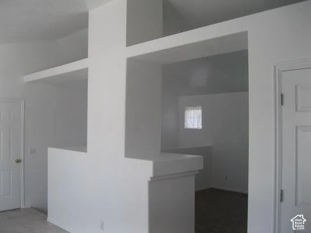 Vaulted ceilings, open concept wall partition, interior window, and paneled doors