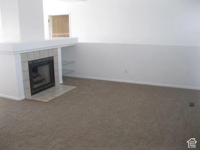Fireplace with tile surround, hearth, and mantel