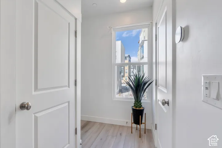 Recessed lighting, wood-finish flooring, and white paneled doors