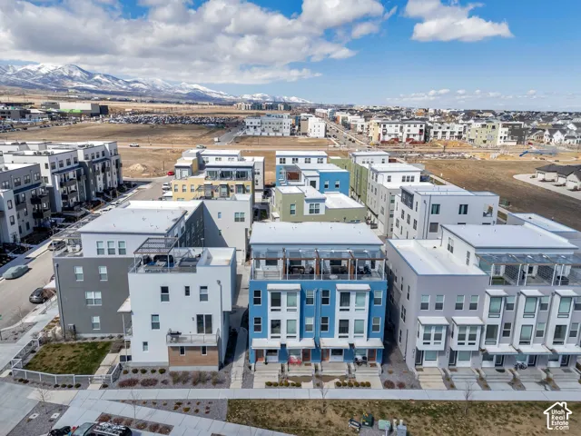 Modern multi-story townhomes featuring rooftop terraces and balconies