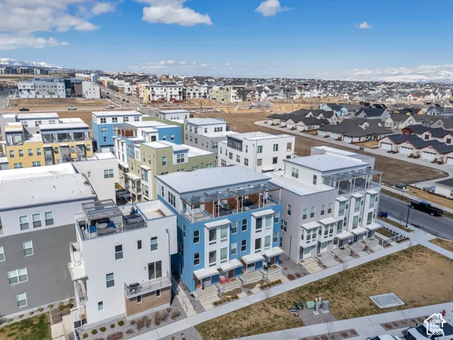 Modern residential development featuring multi-level structures with rooftop patios and integrated balconies