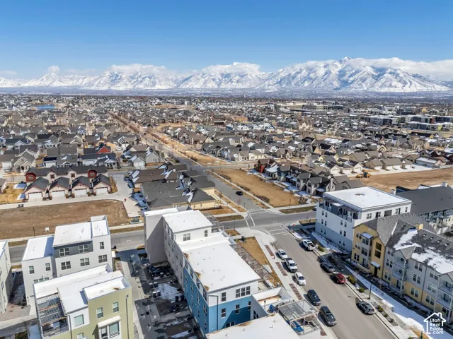 Expansive residential area with a mountain backdrop, featuring a network of streets and various housing structures