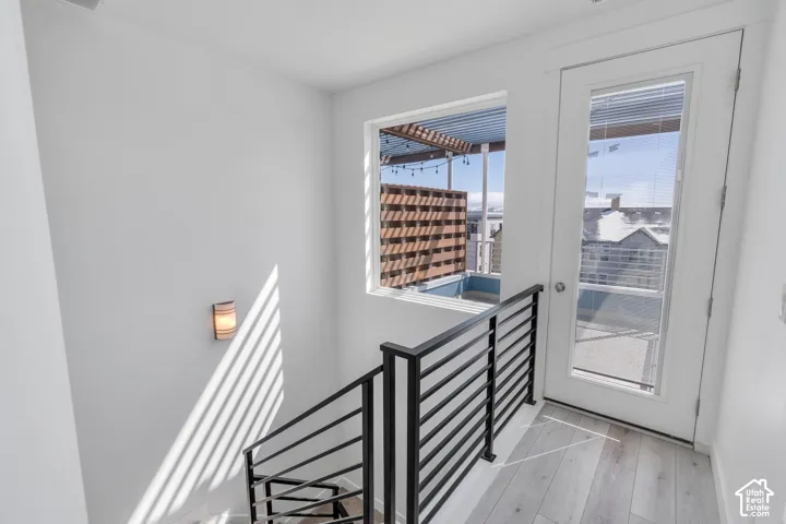 Wood-finish flooring with a modern black metal railing