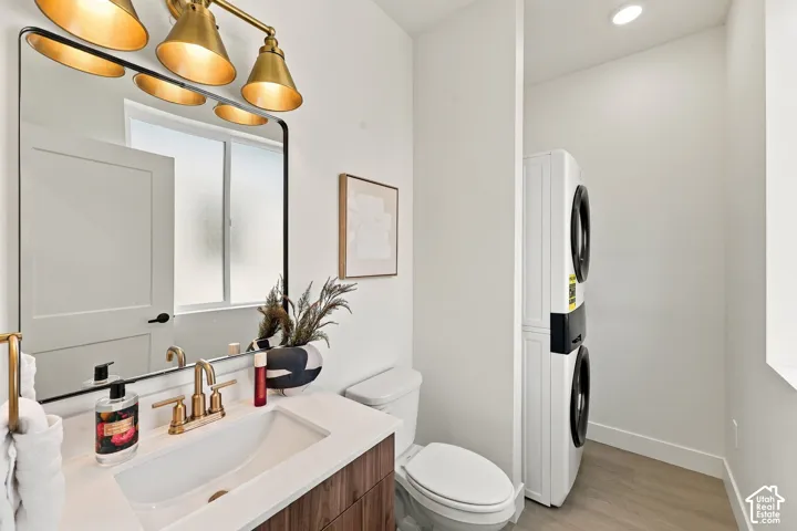 Vanity with white countertop and integrated sink, gold-finish faucet, and coordinating overhead lighting