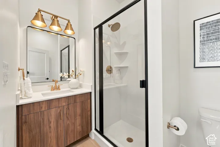 Wood-finish vanity with a rectangular undermount sink and light-toned countertop