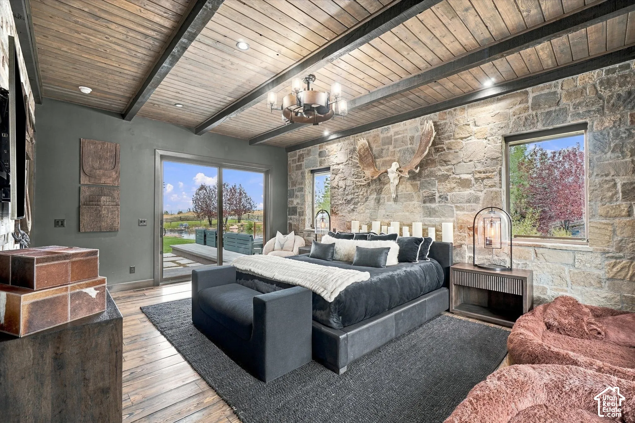 Vaulted wood-plank ceiling with exposed beams and recessed lighting