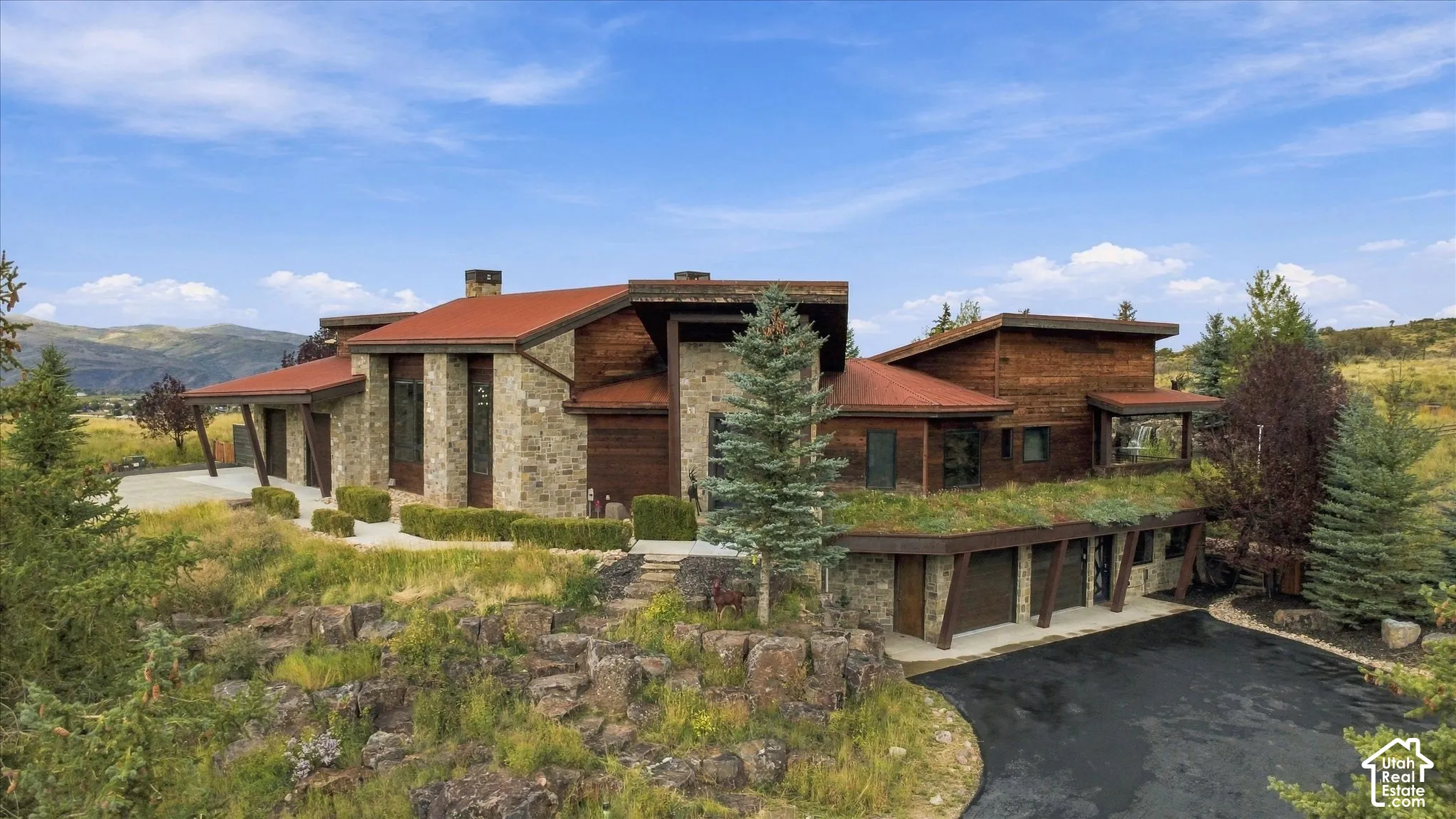Stone and wood-clad exterior with a red tile roof