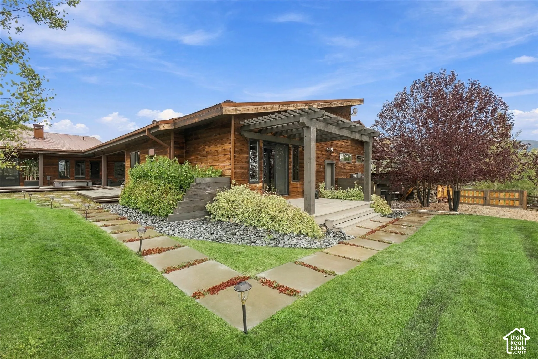 Wood-sided exterior featuring a metal roof and an expansive deck