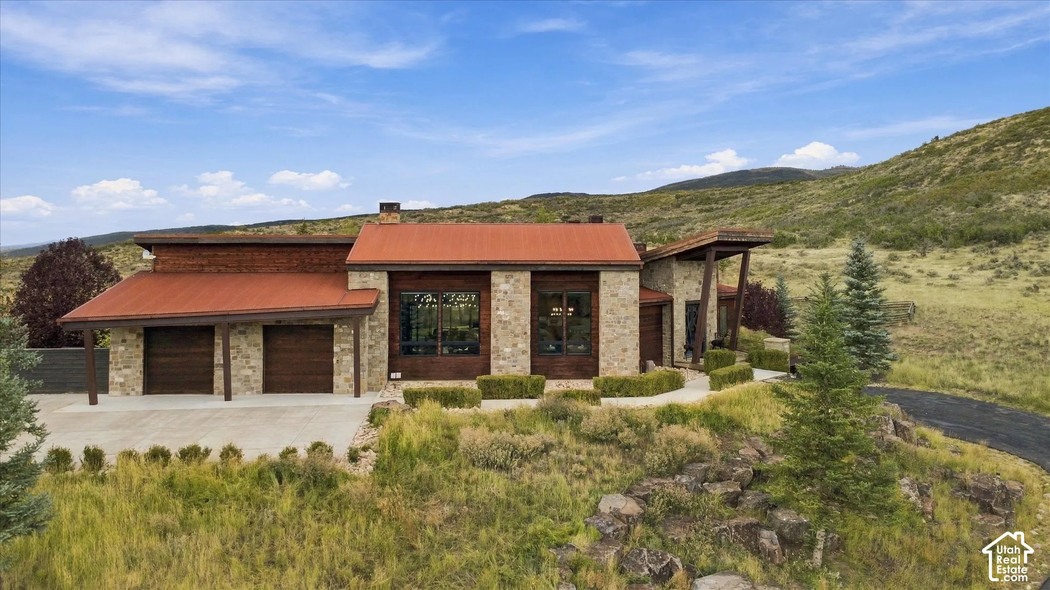 Stone exterior with a red metal roof