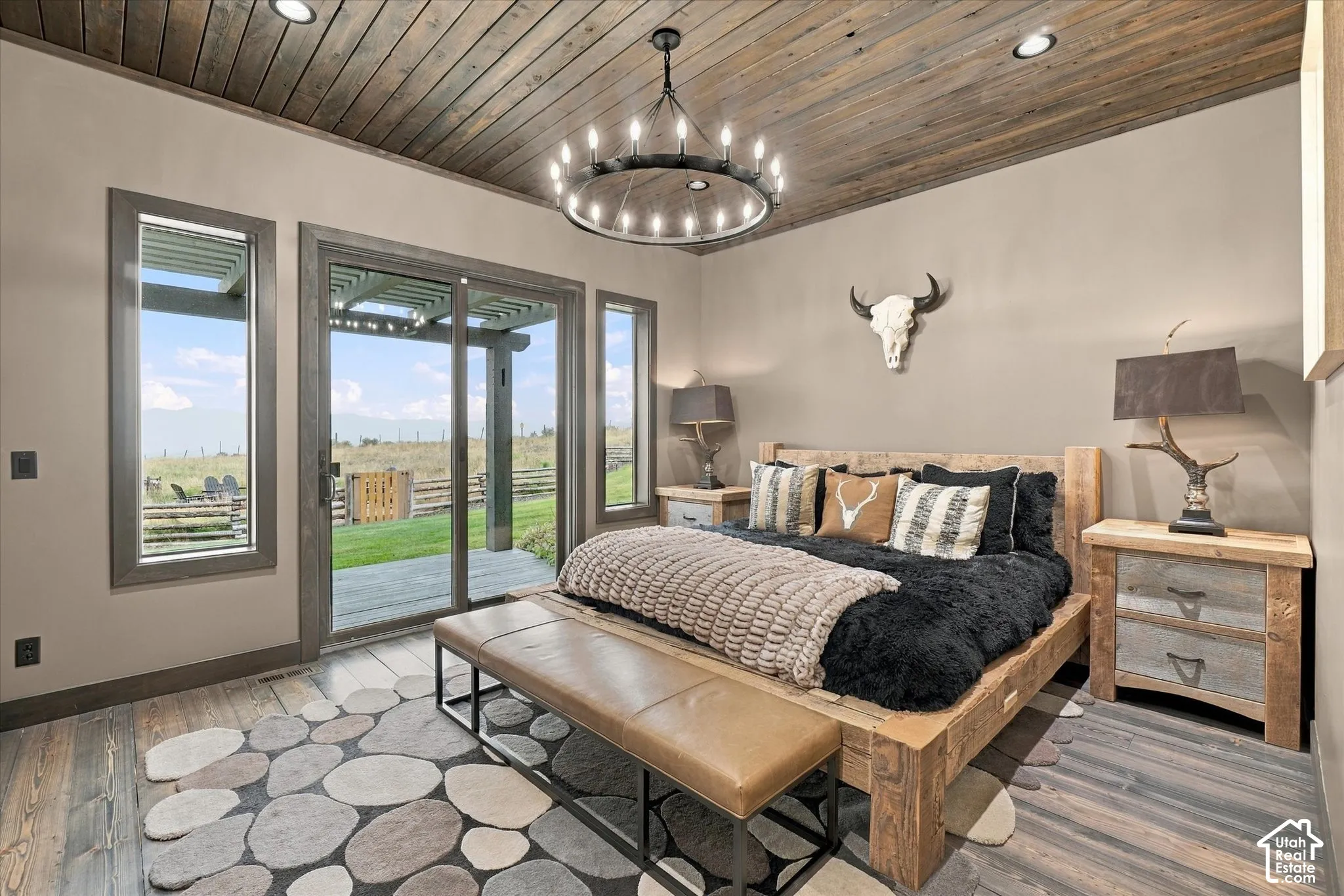 Wood-finish ceiling panels, recessed lighting, wood-finish flooring, sliding glass door, and fixed pane windows