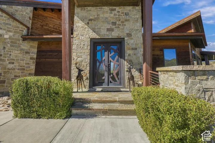 Stone facade with wood-finish siding and a metal roof