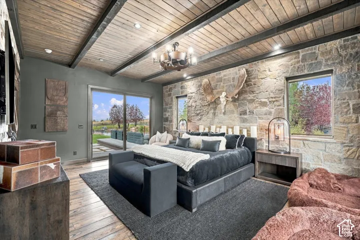 Vaulted wood-plank ceiling with exposed beams and recessed lighting