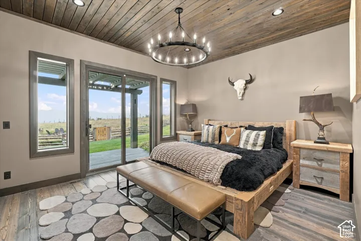 Wood-finish ceiling panels, recessed lighting, wood-finish flooring, sliding glass door, and fixed pane windows