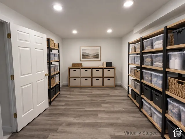 Recessed lighting illuminates wood-finish flooring