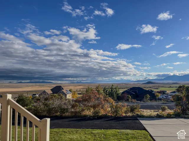Expansive mountain range backdrop with distant plains