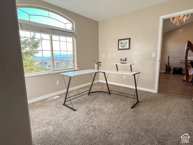 Arched transom window with grid, large picture window, and neutral wall color