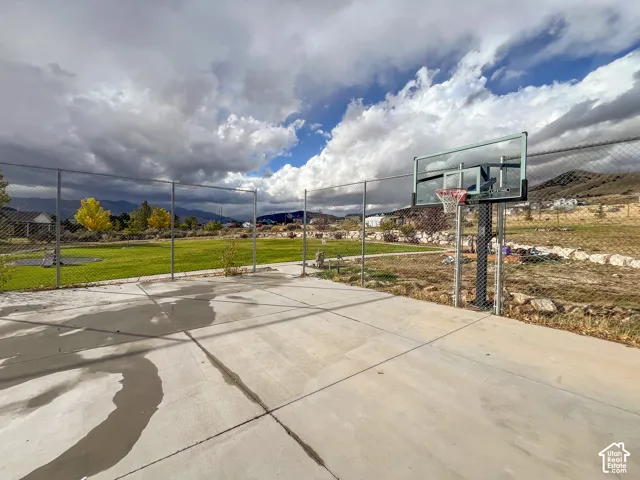 Outdoor concrete sports court with a basketball hoop