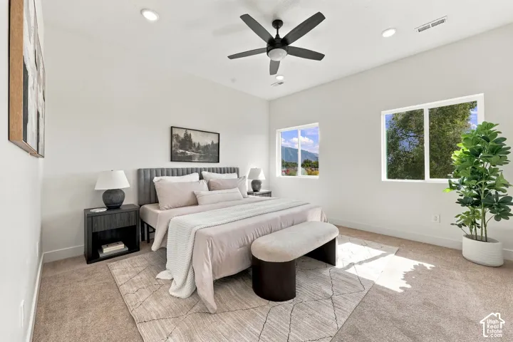 Recessed lighting, ceiling fan, and multiple windows providing ample natural light