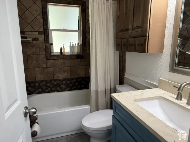 Vanity with light-toned countertop and integrated sink, brushed nickel faucet, and blue-painted cabinet