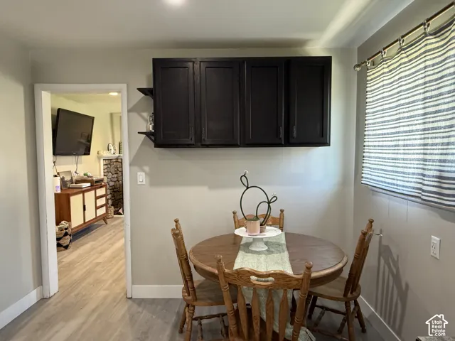 Built-in upper cabinetry with shelving, recessed lighting, and wood-finish flooring