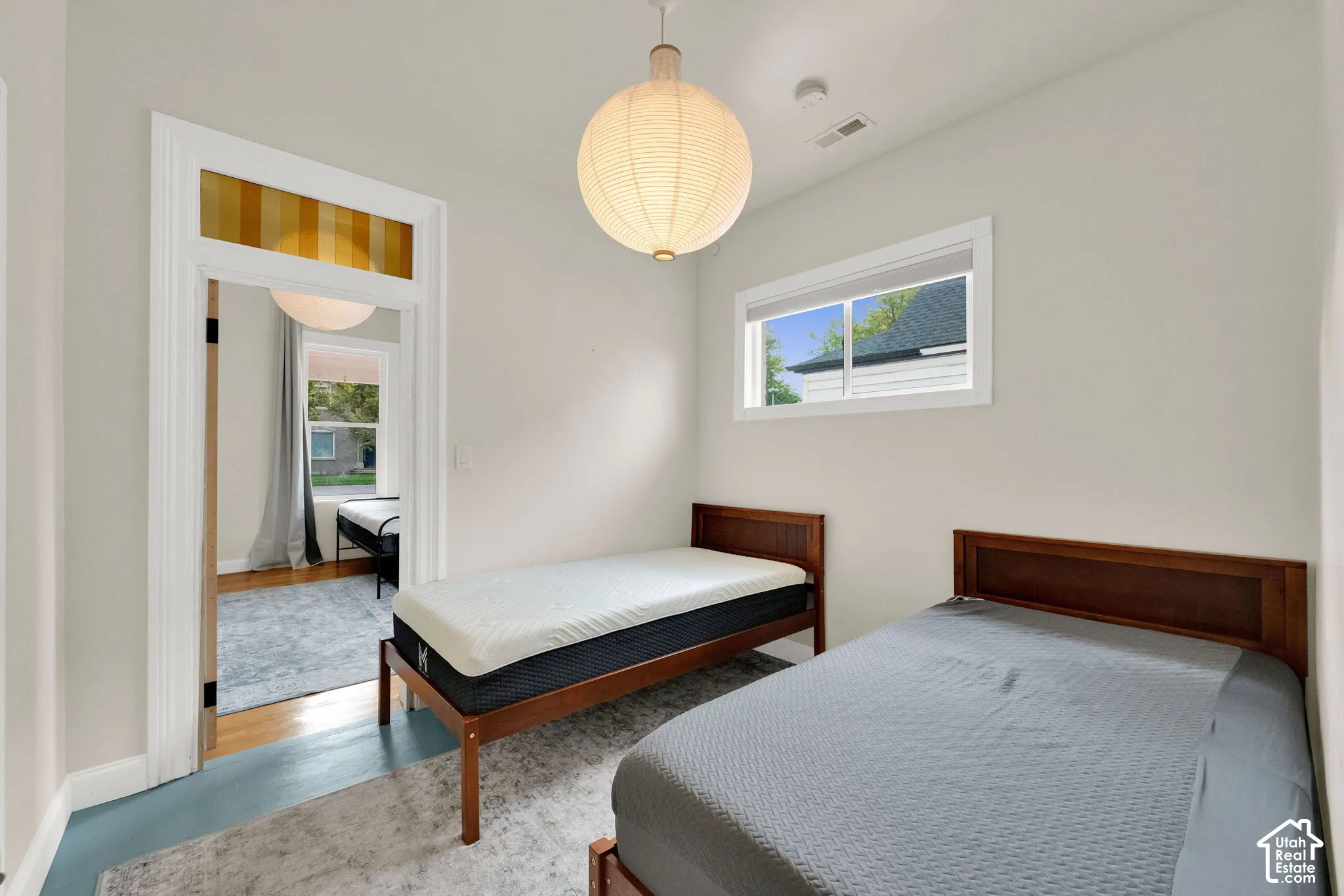 Recessed window with white trim, light wall color, and a decorative pendant light fixture