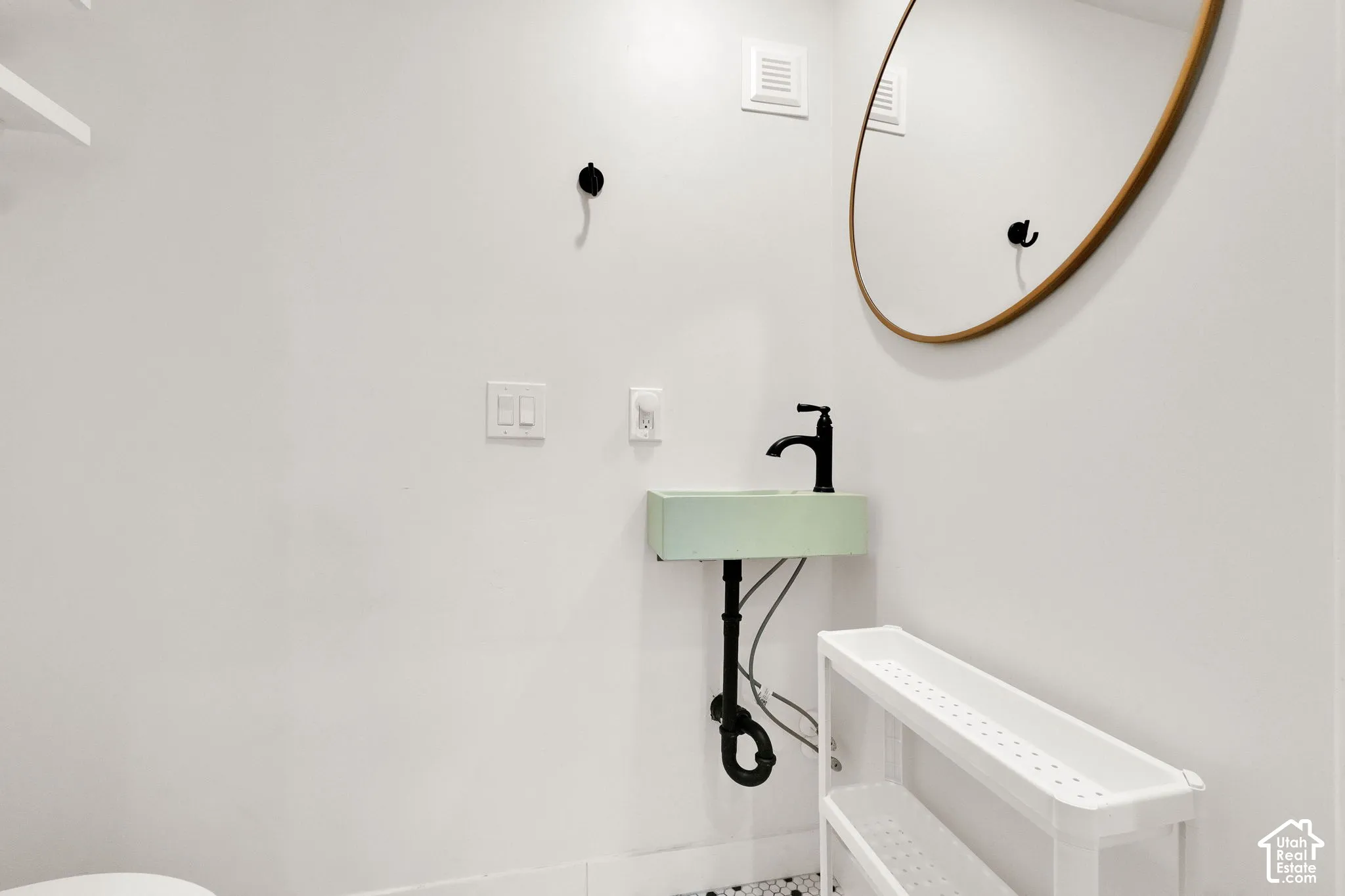 Wall-mounted sink with matte black faucet
