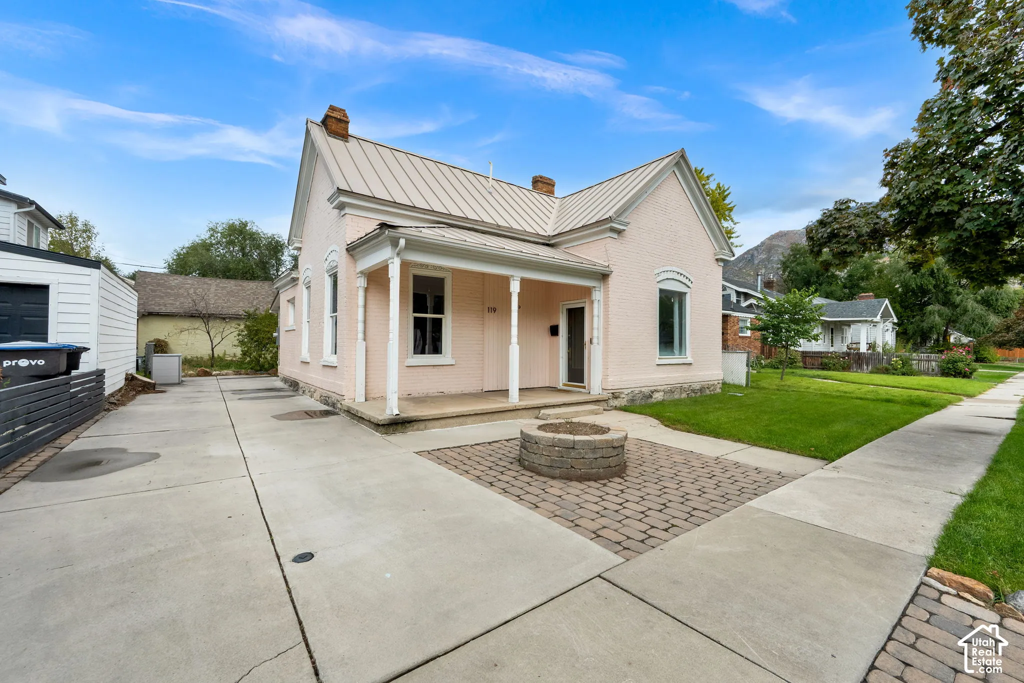 Single-story residence with a metal roof and a covered front porch with columns