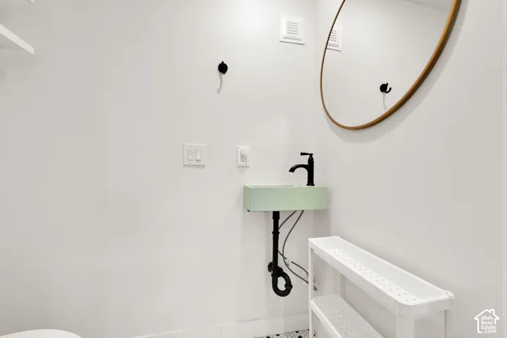 Wall-mounted sink with matte black faucet