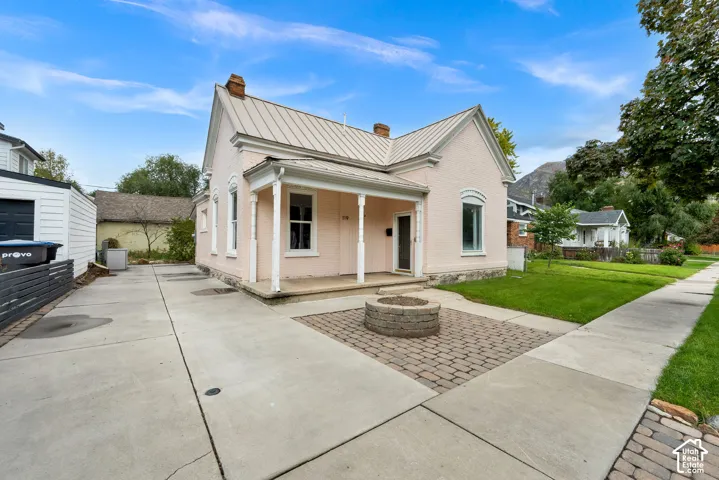 Single-story residence with a metal roof and a covered front porch with columns