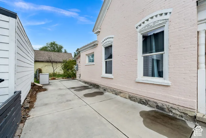 Brick exterior with decorative window trim and a stone foundation