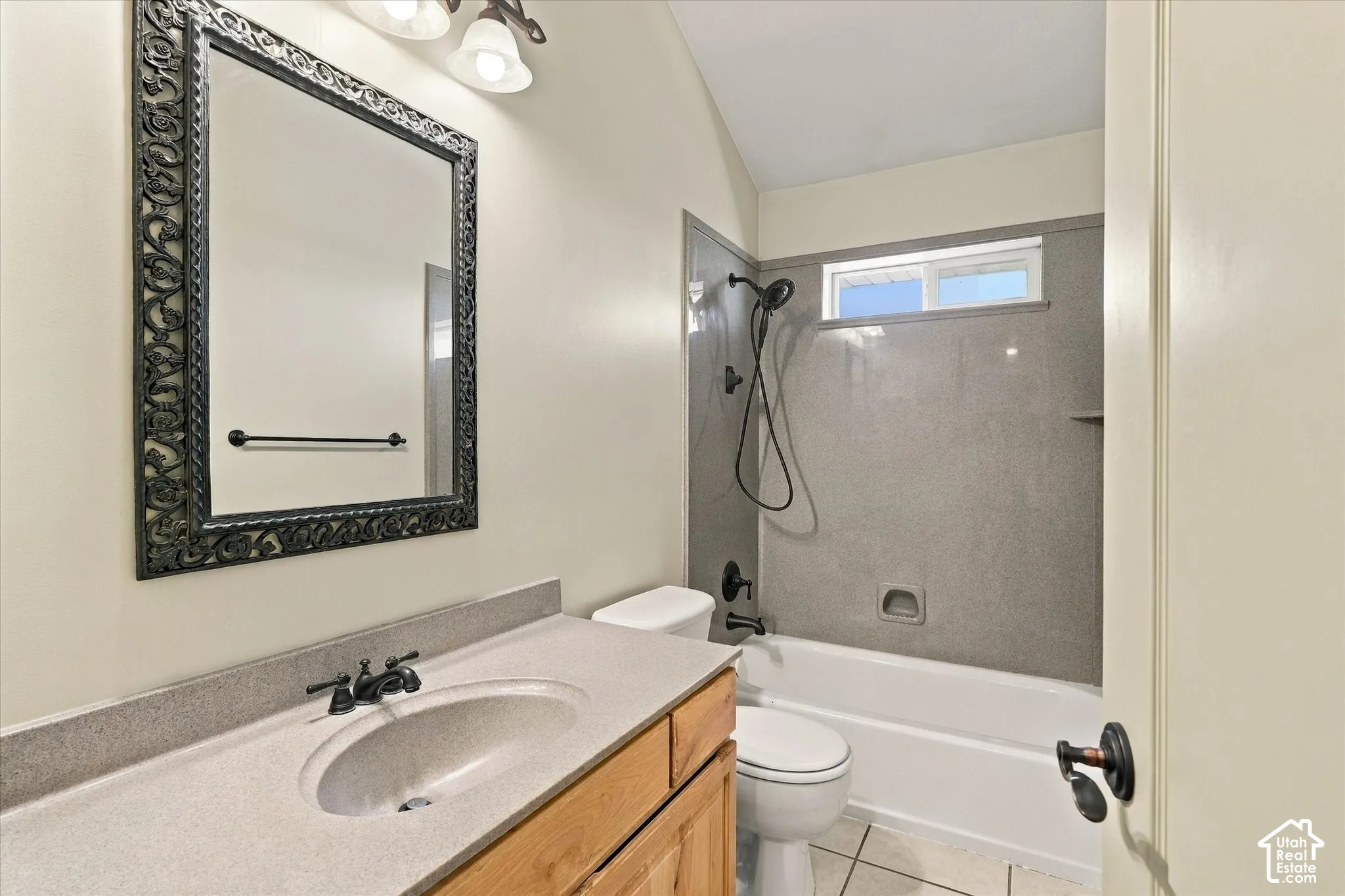 Wood-finish vanity with an integrated sink and bronze-finish faucet