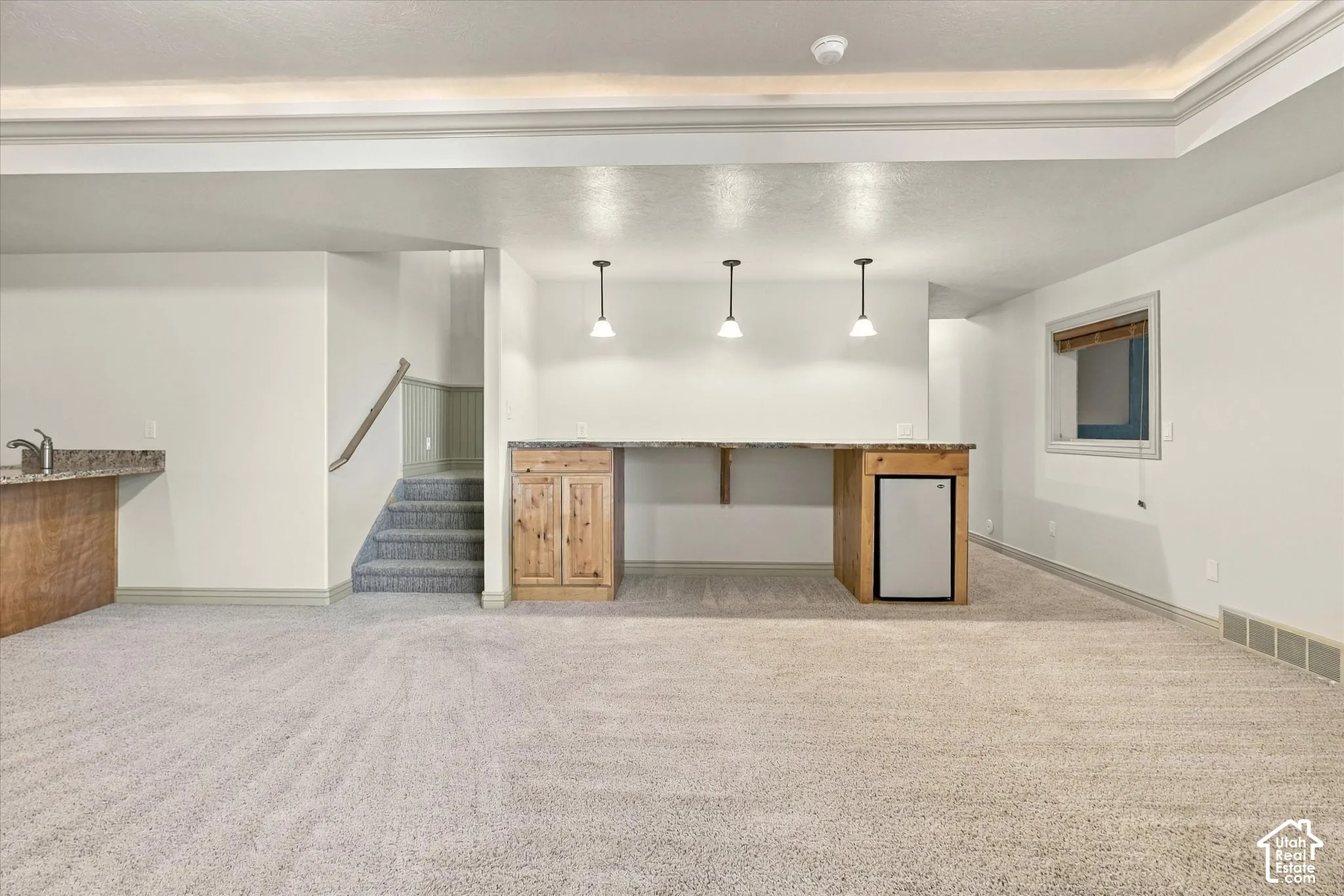 Finished lower level with recessed lighting and neutral carpeting