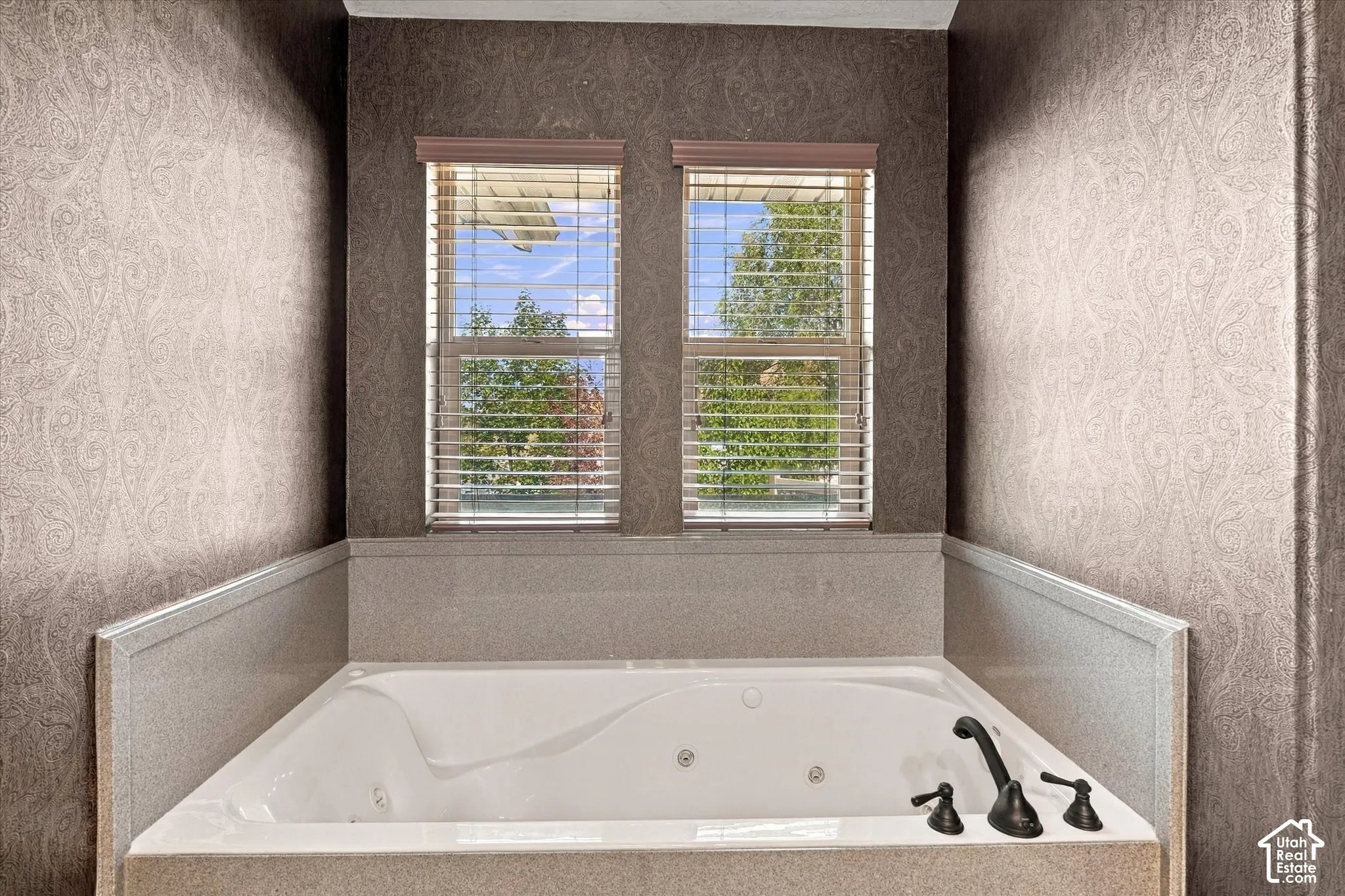 Built-in jetted tub with dark bronze fixtures