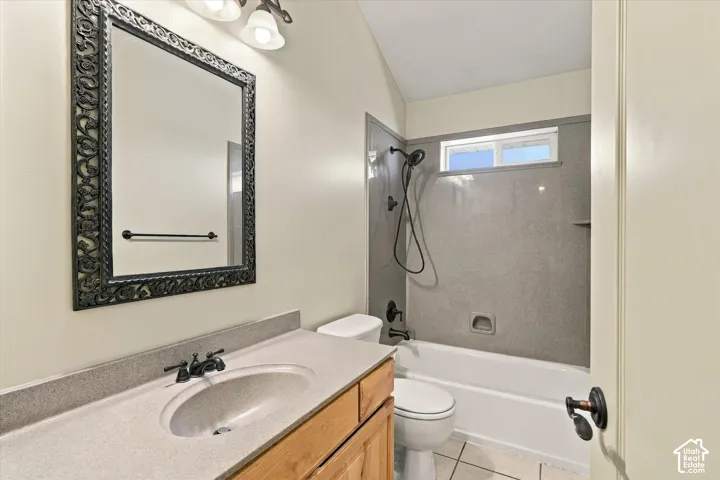 Wood-finish vanity with an integrated sink and bronze-finish faucet