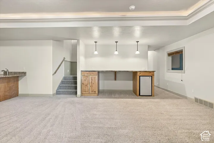 Finished lower level with recessed lighting and neutral carpeting