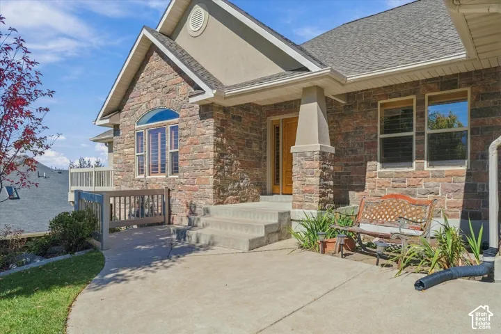 Stone and stucco exterior with multiple gables and a covered entry