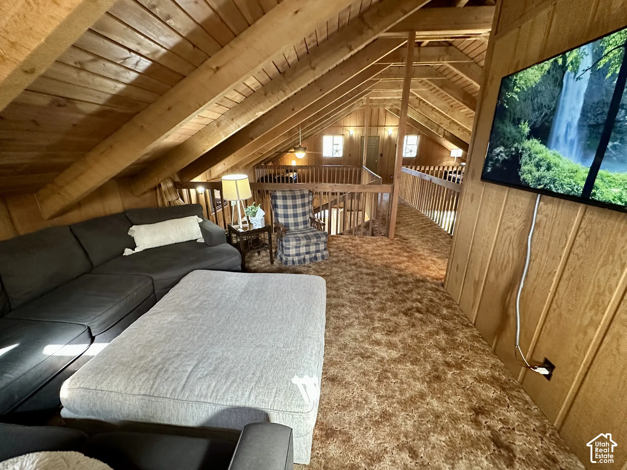 Wood-paneled walls and ceiling with exposed wood beams