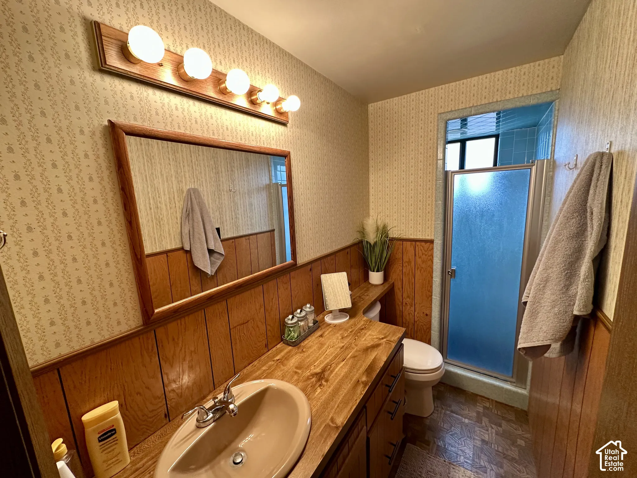 Wood-finish vanity with an integrated sink, framed mirror, and built-in cabinetry