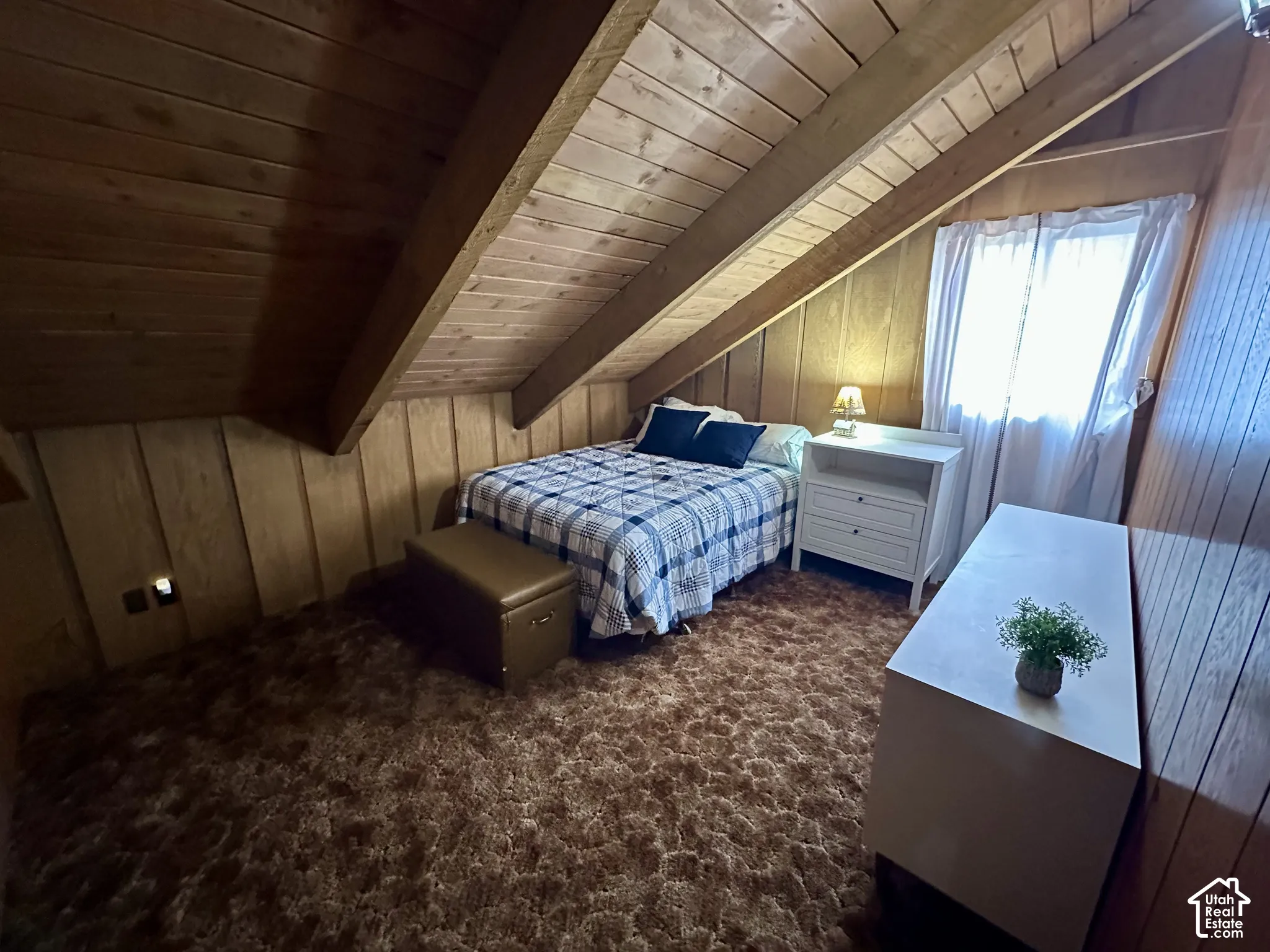 Wood-paneled walls and ceiling with exposed beams