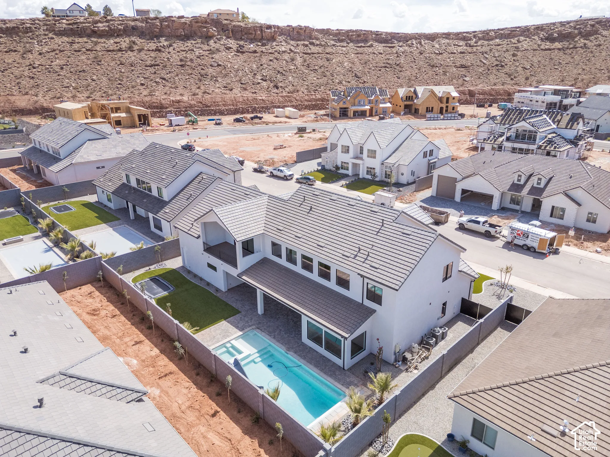 Modern architectural style with a white stucco exterior and dark-toned roof