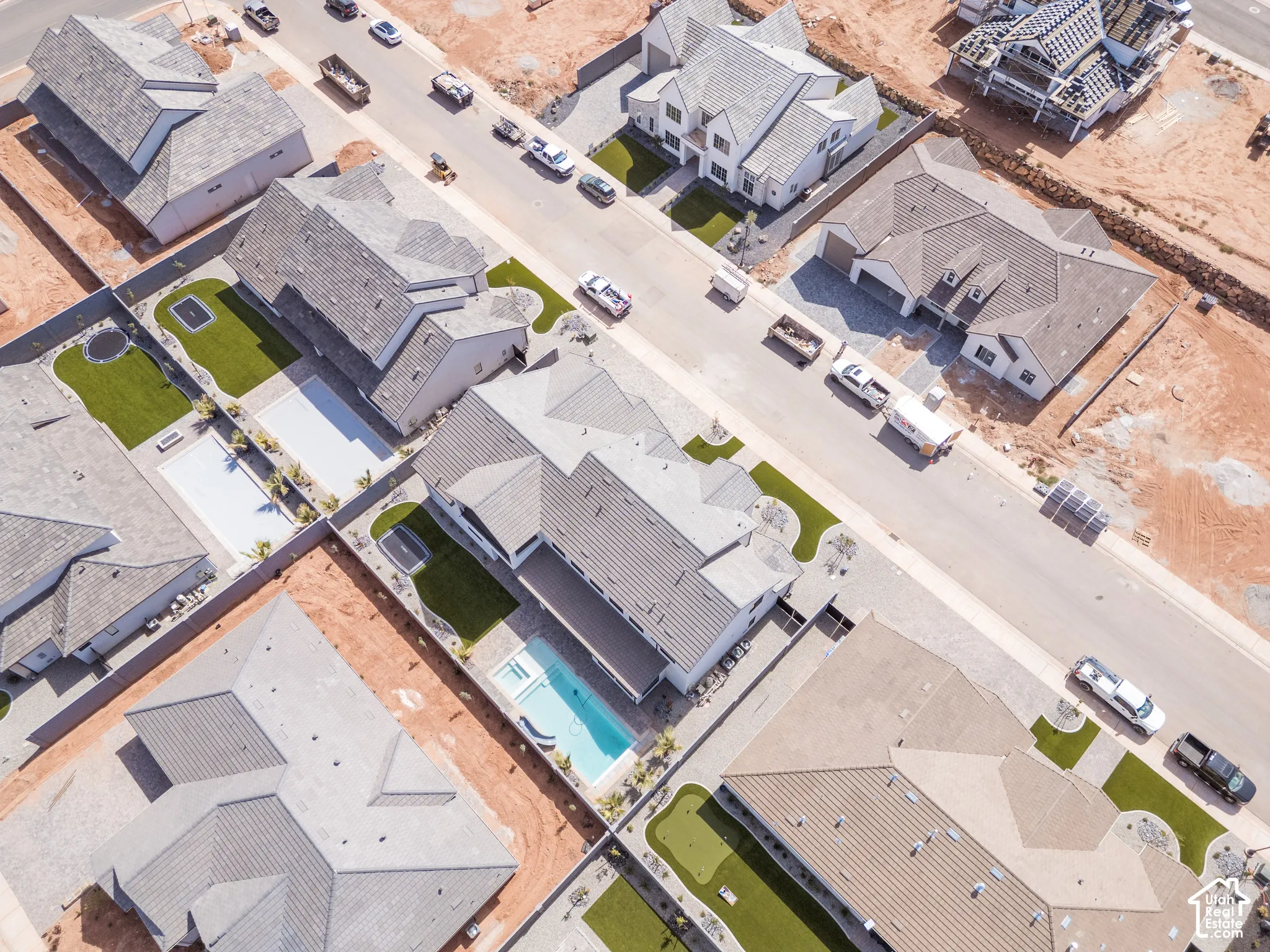 Aerial perspective showcasing residential properties with varied rooflines and front yard landscaping