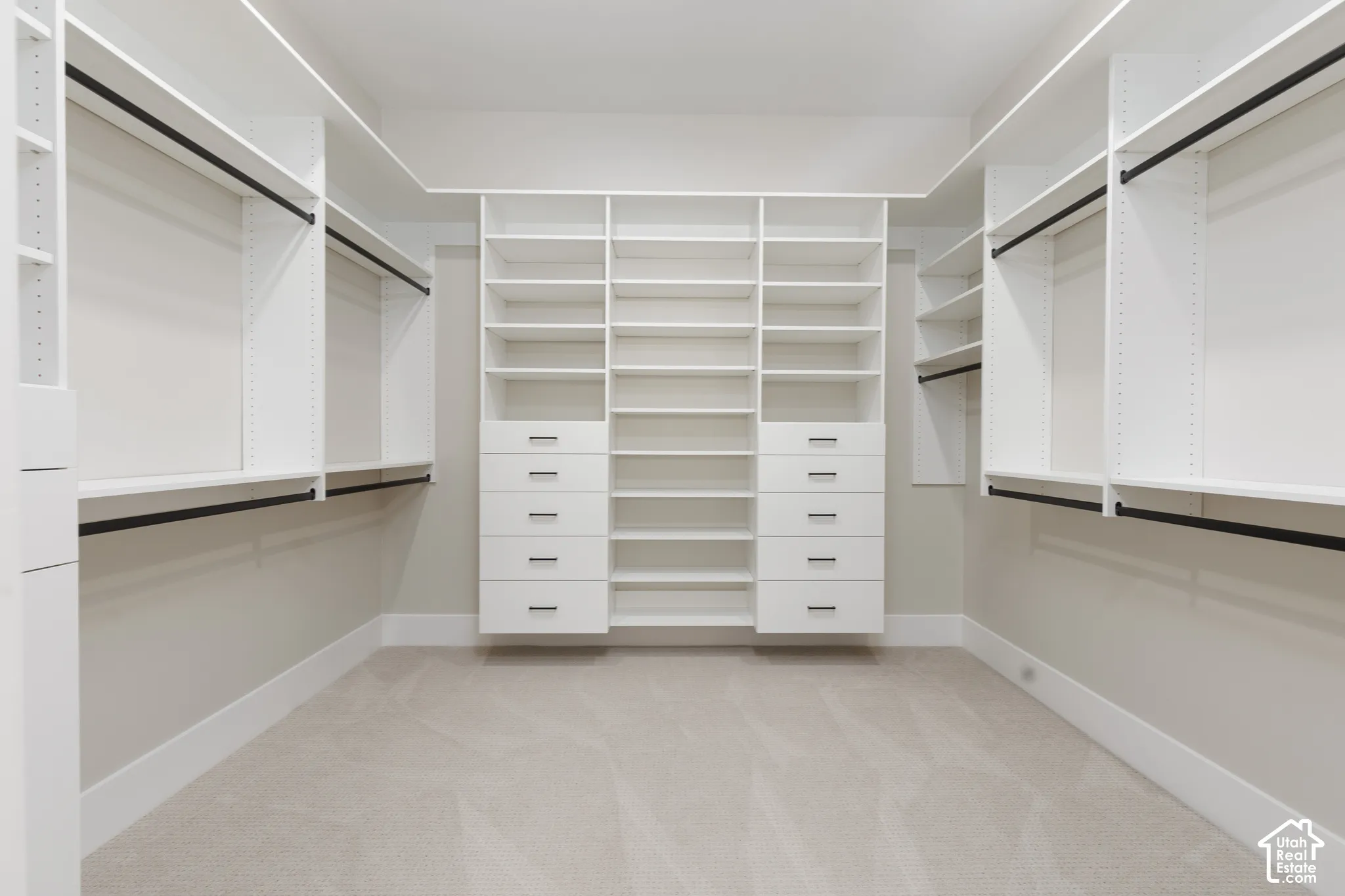 Built-in closet system with shelving, drawers, and hanging rods